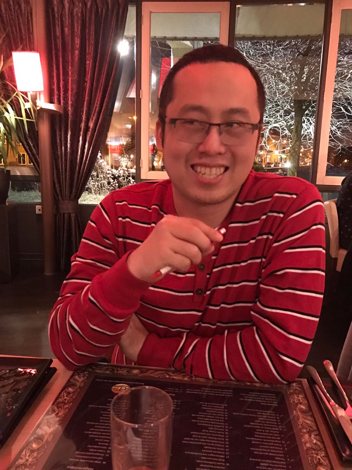 Portrait of CSLIM, smiling in a red striped sweater